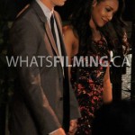 Barry and Iris holding hands as they walk while filming a scene for The Flash season 3 episode 3