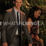 Barry and Iris holding hands as they walk while filming a scene for The Flash season 3 episode 3