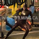Action shot of The Flash with rope on his shoulder