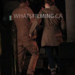 Caitlin Snow and Julian Albert lock arms as they walk while filming a scene for The Flash season 3 episode 13 in Vancouver