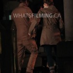 Caitlin Snow and Julian Albert lock arms as they walk